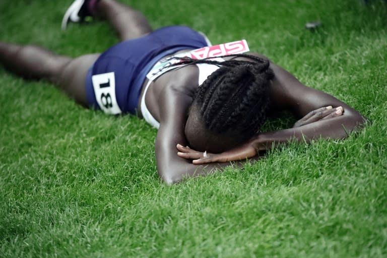 Israel's Lonah Chemtai Salpeter, who pulled up a lap short thinking the race was over, lays on the grass after the women's 5000m final race at the European Athletics Championships at the Olympic stadium in Berlin on August 12, 2018