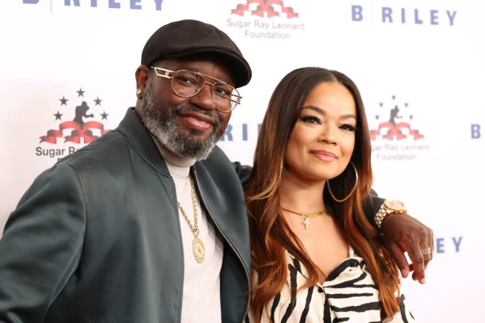 Closeup of Lil Rel with his arm around Dannella's shoulder as they stand on the red carpet