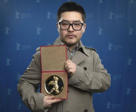 Na Young-kil poses with the Golden Bear Prize of the International Short Film Jury for his film Film 'Hosanna' during the awards ceremony at the 65th Berlinale International Film Festival in Berlin February 14, 2015. REUTERS/Tim Brakemeier/Pool