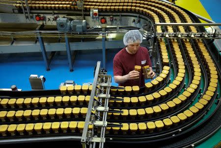 A staff member performs a visual check on packages in the Nescafe production facility in Orbe, Switzerland March 25, 2013. REUTERS/Denis Balibouse/File Photo