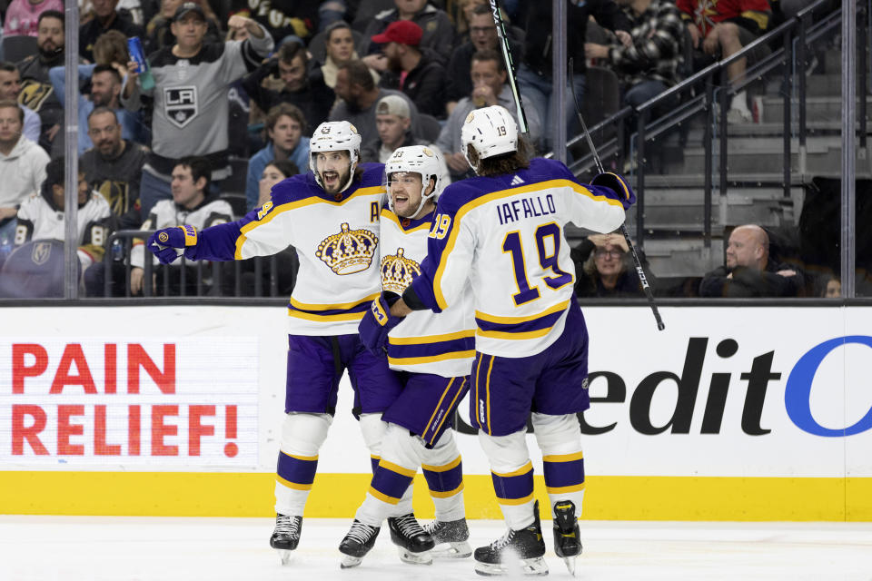 Los Angeles Kings center Phillip Danault (24), right wing Viktor Arvidsson (33) and left wing Alex Iafallo (19) celebrate after Arvidsson scored against the Vegas Golden Knights during the third period of an NHL hockey game Saturday, Jan. 7, 2023, in Las Vegas. (AP Photo/Ellen Schmidt)