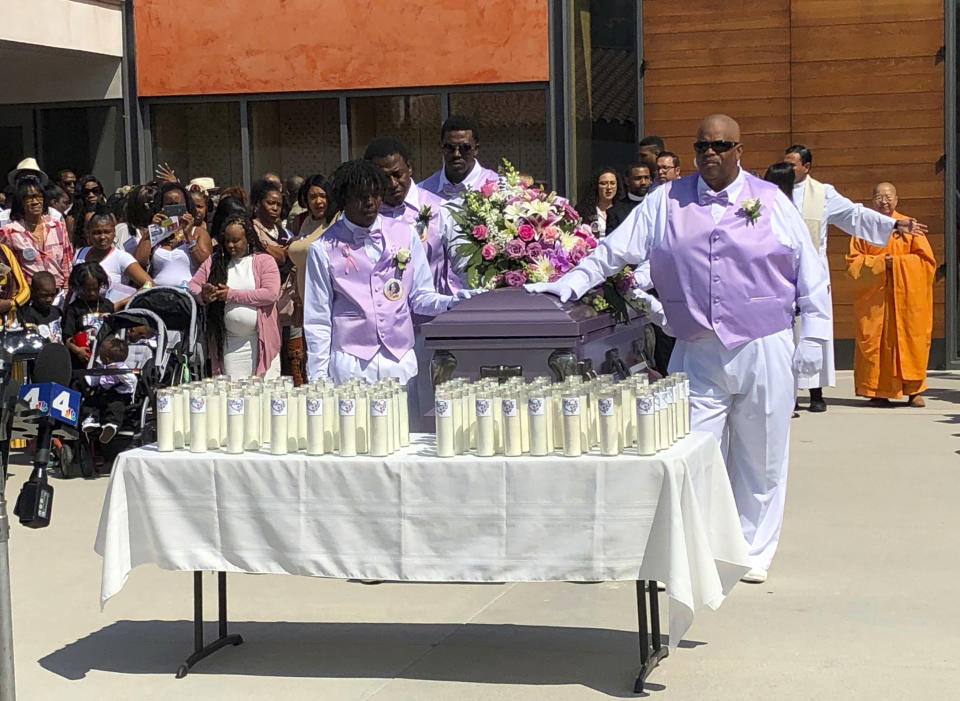 Mourners attend the funeral service of Trinity Love Jones, the 9-year-old whose body was found this month stuffed in a duffel bag along an equestrian trail, at St. John Vianney Catholic Church in Hacienda Heights, Calif., Monday, March 25, 2019. The Hacienda Heights community where her body was found had embraced the child in death during the days she remained unidentified. A park worker found Trinity on March 5. A huge memorial sprang up at the site as community members heard about the case. She was identified the following weekend and prosecutors have since filed murder charges against her mother and the mother's boyfriend. (AP Photo/John Rogers)