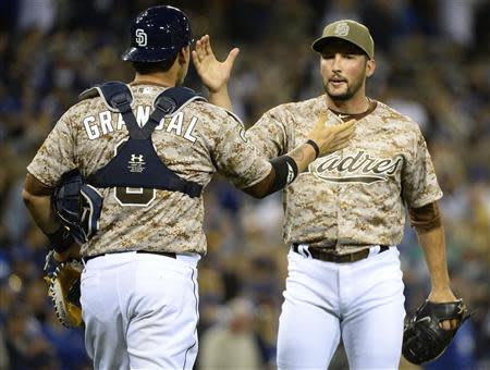 Mar 30, 2014; San Diego, CA, USA; San Diego Padres relief pitcher Huston Street (16) celebrates with catcher Yasmani Grandal (8) after winning the opening day baseball game against the Los Angeles Dodgers at Petco Park. Christopher Hanewinckel-USA TODAY Sports