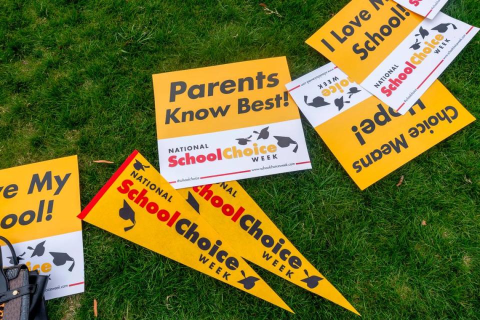 Signs lay in the grass during a rally celebrating National School Choice Week on Halifax Mall in front of the Legislative Building in Raleigh on Wednesday, Jan. 24, 2024.