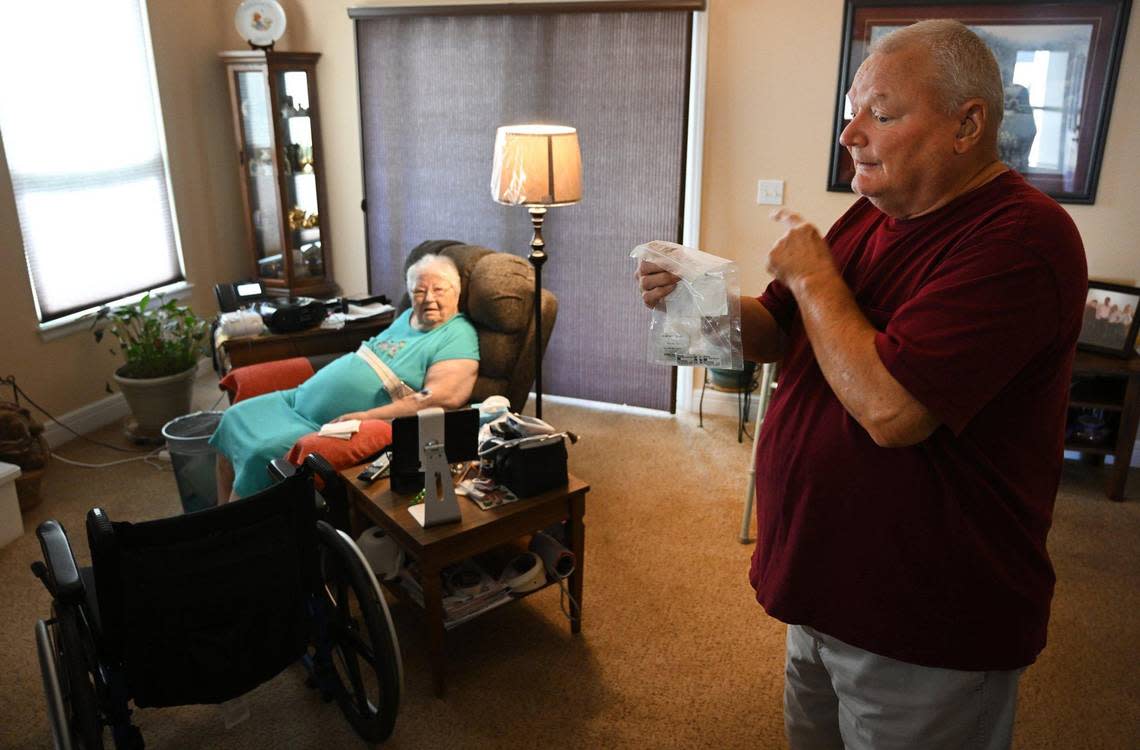 Lee Saunders holds the medications that were delivered via courier to his Grain Valley home, where he takes care of his wife, Delores. She is one of the first participants in the new Hospital in Your Home program offered by Saint Luke’s East Hospital.