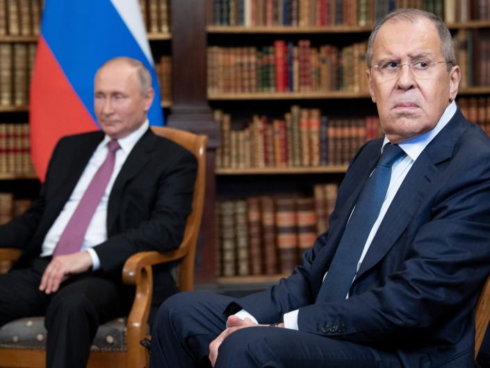 Russian Foreign Minister Sergei Lavrov looks on, next to Russian President Vladimir Putin, as they wait for the US-Russia summit at the Villa La Grange, in Geneva on June 16, 2021.