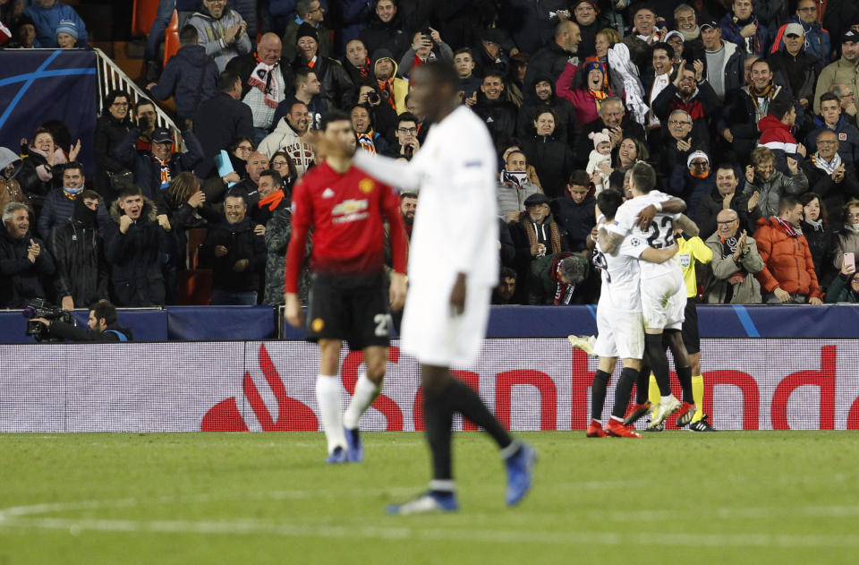 Valencia players celebrate after Manchester United's Phil Jones scores an own goal during a Group H Champions League soccer match between Valencia and Manchester United at the Mestalla Stadium in Valencia, Spain, Wednesday, Dec. 12, 2018. (AP Photo/Alberto Saiz)