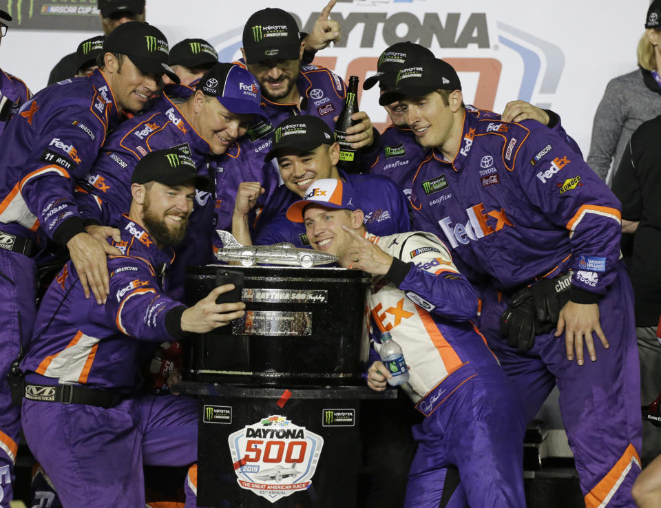 Denny Hamlin and his team with the Harley J. Earl trophy after winning the 2019 Daytona 500. (AP Photo/Terry Renna)