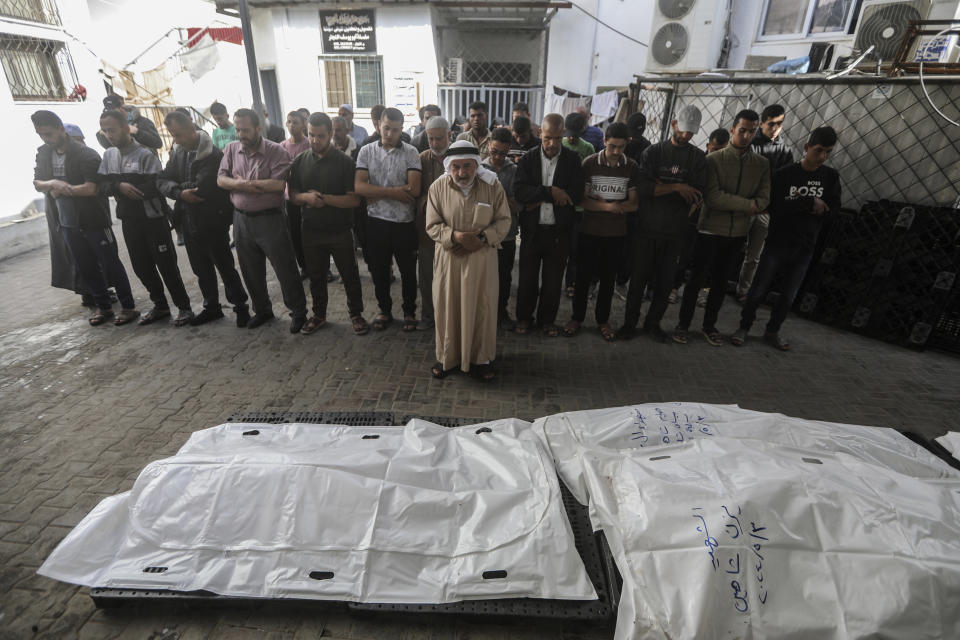 Mourners pray for two adults and five boys and girls under the age of 16 from the Chahine family after an overnight Israeli strike in Rafah, southern Gaza Strip, Friday, May 3, 2024. An Israeli strike on the city of Rafah on the southern edge of the Gaza Strip killed several people, including children, hospital officials said Friday. (AP Photo/Ismael Abu Dayyah)