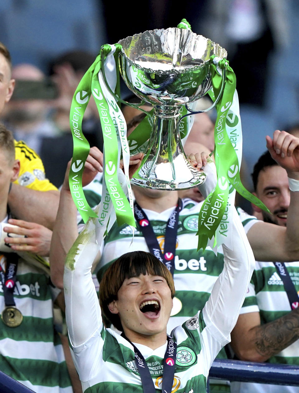 Celtic's Kyogo Furuhashi lifts the cup after the Scottish League Cup Final against Rangers at Hampden Park, Glasgow, Scotland, Sunday Feb. 26, 2023. (Andrew Milligan/PA via AP)