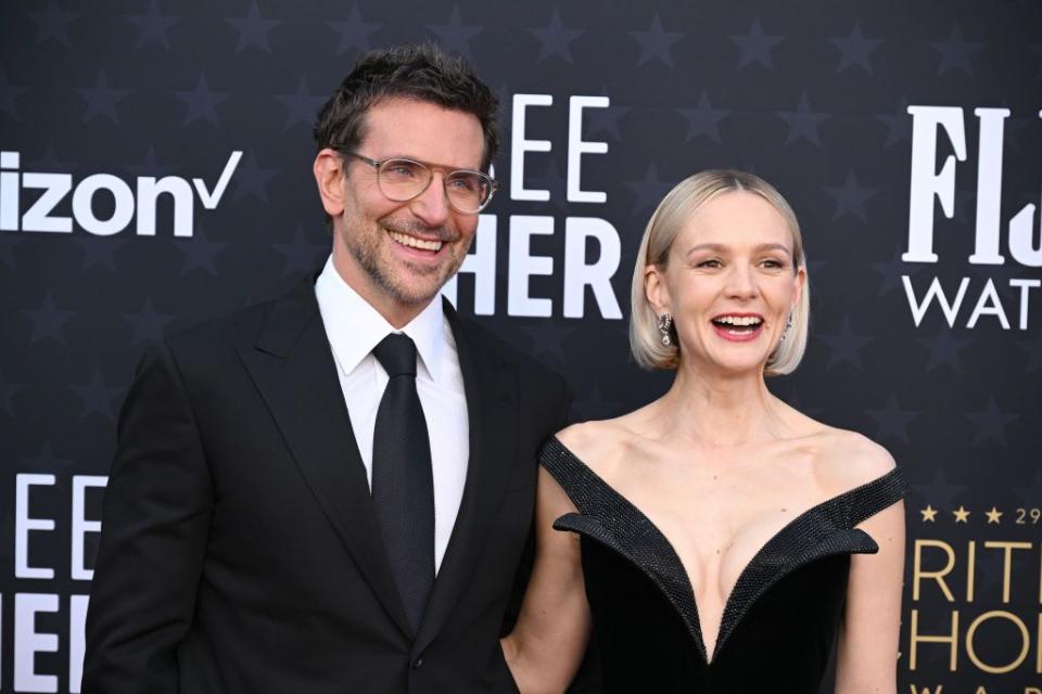 bradley cooper standing next to carey mulligan for a photo with both smiling