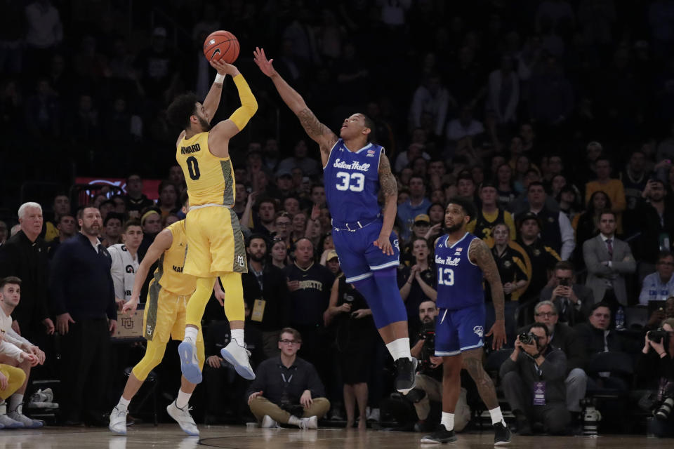 Marquette guard Markus Howard (0) attempts a shot against Seton Hall guard Shavar Reynolds (33) during the second half of an NCAA college basketball semifinal game in the Big East men's tournament, early Saturday, March 16, 2019, in New York. Seton Hall won 81-79. (AP Photo/Julio Cortez)