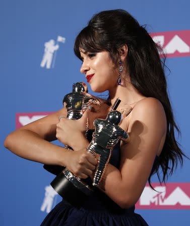 2018 MTV Video Music Awards - Photo Room - Radio City Music Hall, New York, U.S., August 20, 2018. - Camila Cabello poses backstage with her awards for Artist of the Year and Video of the Year for "Havana." REUTERS/Carlo Allegri