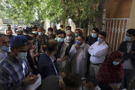 Residents, wearing face masks to help curb the spread of the coronavirus, line up to receive the Sinopharm COVID-19 vaccine at a vaccination center, in Kabul, Afghanistan, Wednesday, June 16, 2021. In Afghanistan, where a surge threatens to overwhelm a war-battered health system, 700,000 doses donated by China arrived over the weekend, and within hours, "people were fighting with each other to get to the front of the line," said Health Ministry spokesman Dr. Ghulam Dastigir Nazari. (AP Photo/Rahmat Gul)