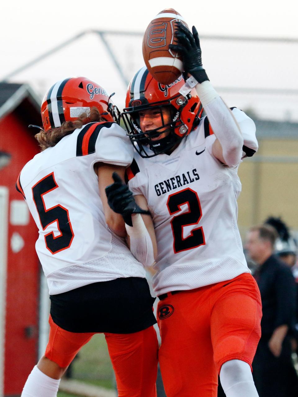 Ridgewood receiver Josiah Cahill celebrates with Mason Colvin, left, after catching a 48-yard touchdown pass during the second quarter of a 42-14 win against host Coshocton on Friday night at Stewart Field. 