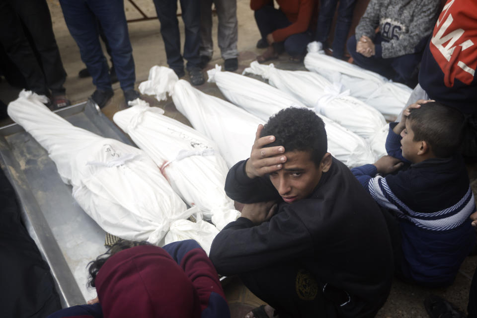 Palestinians mourn relatives killed in the Israeli bombardment of the Gaza Strip outside a morgue in Khan Younis on Thursday, Jan. 4, 2024. (AP Photo/Mohammed Dahman)