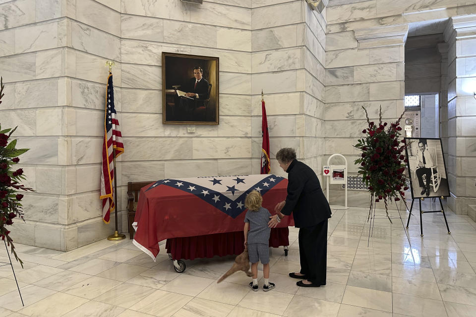 Barbara Pryor, the widow of former Arkansas governor and U.S. Sen. David Pryor, stands before Pryor's casket with their great-grandson Raven at the Arkansas state Capitol in Little Rock, Arkansas on Friday, April 26, 2024. David Pryor died in Little Rock on April 20, 2024. Pryor, a Democrat, remained active in public service long after he left public office. (AP Photo/Andrew DeMillo)