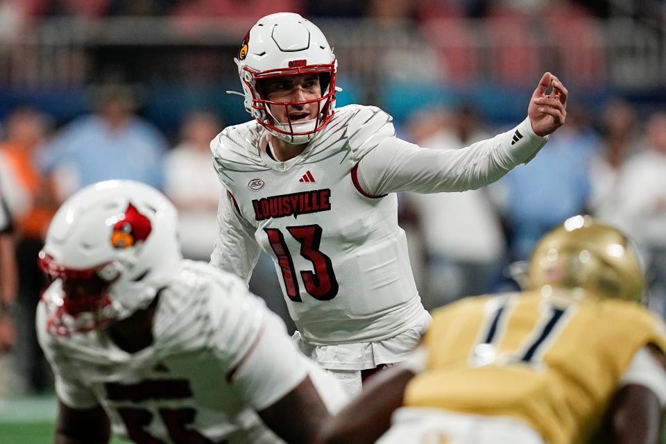 Louisville quarterback Jack Plummer (13) calls an audible against Georgia Tech during the first half of an NCAA college football game, Friday, Sept. 1, 2023, in Atlanta. (AP Photo/Mike Stewart)