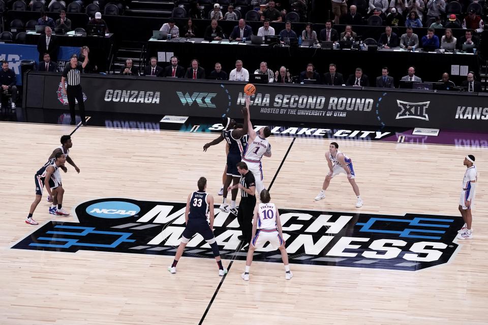 Gonzaga's Graham Ike (13) and Kansas' Hunter Dickinson (1) tip off during the first half of a NCAA tournament college basketball game on March 23, 2024 in Salt Lake City, Utah.