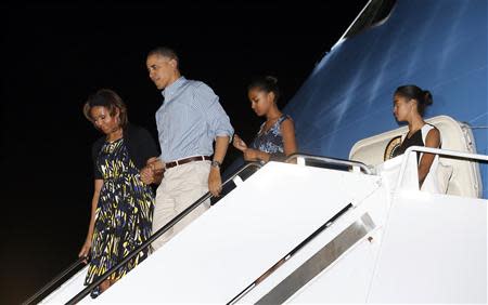 U.S. President Barack Obama (2nd L) and his family, (from L to R) Michelle Obama, Obama, Sasha and Malia, step from Air Force One upon their arrival for their vacation in Honolulu, in Hawaii December 20, 2013. REUTERS/Kevin Lamarque