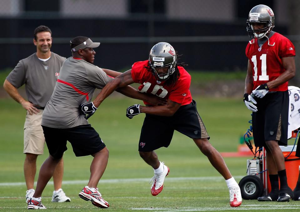 TAMPA, FL - MAY 01:  Head coach Raheem Morris of the Tampa Bay Buccaneers works with receiver Chris Bonner #10 during the Buccaneers Rookie mini camp at One Buccaneer Place on May 1, 2010 in Tampa, Florida.  (Photo by J. Meric/Getty Images)