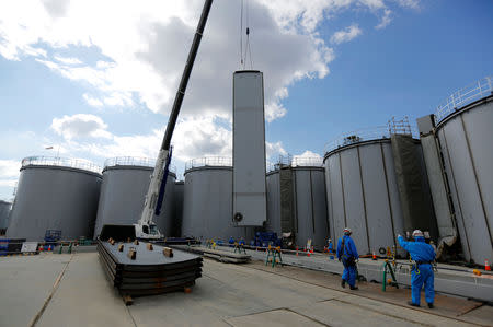 Workers conduct construction task for a storage tank for radioactive water at Tokyo Electric Power Co's (TEPCO) tsunami-crippled Fukushima Daiichi nuclear power plant in Okuma town, Fukushima prefecture, Japan February 18, 2019. Picture taken February 18, 2019. REUTERS/Issei Kato