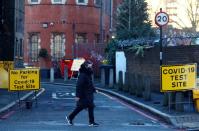 A person walks past the entrance to a testing site, amid the coronavirus disease (COVID-19) pandemic, in London