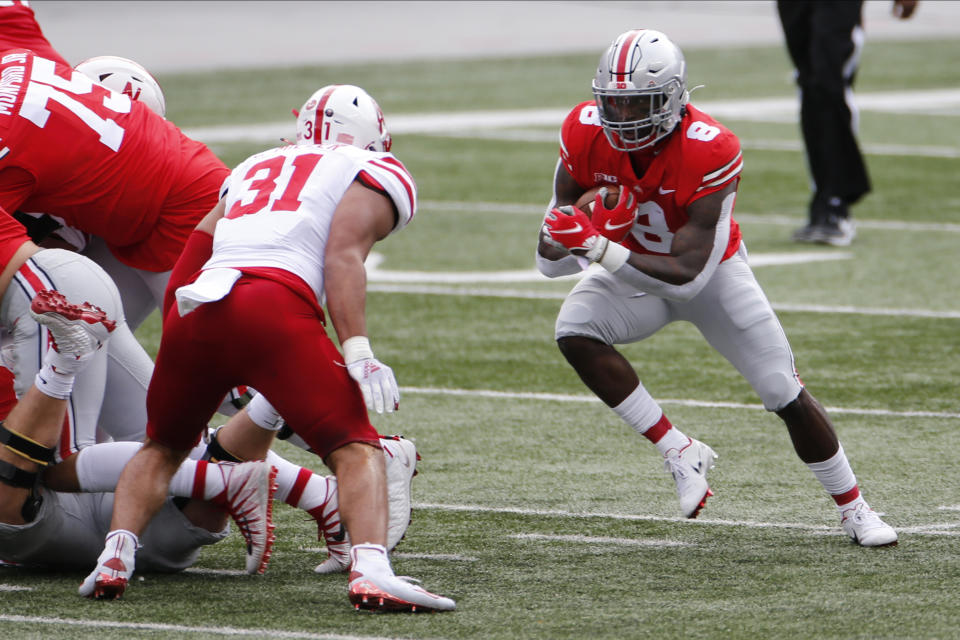 Ohio State running back Trey Sermon, right, cuts up field against Nebraska linebacker Collin Miller during the first half of an NCAA college football game Saturday, Oct. 24, 2020, in Columbus, Ohio. (AP Photo/Jay LaPrete)