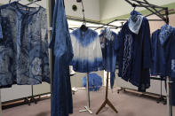 In this image from video, several clothes dyed by members of indigo dye group Japan Blue are displayed at a community center where residents evacuated when the big quake hit the area 10 years ago in Minamisoma, Fukushima Prefecture, northeastern Japan, on Feb. 20, 2021. After the Fukushima nuclear plant disaster a decade ago, nearby farmers weren't allowed to grow crops for two years because of radiation. After the restriction was lifted, two farmers in the town of Minamisoma found an unusual way to rebuild their lives and help their destroyed community. Kiyoko Mori and Yoshiko Ogura planted indigo and soon began dying fabric with dye produced from the plants.(AP Photo/Chisato Tanaka)