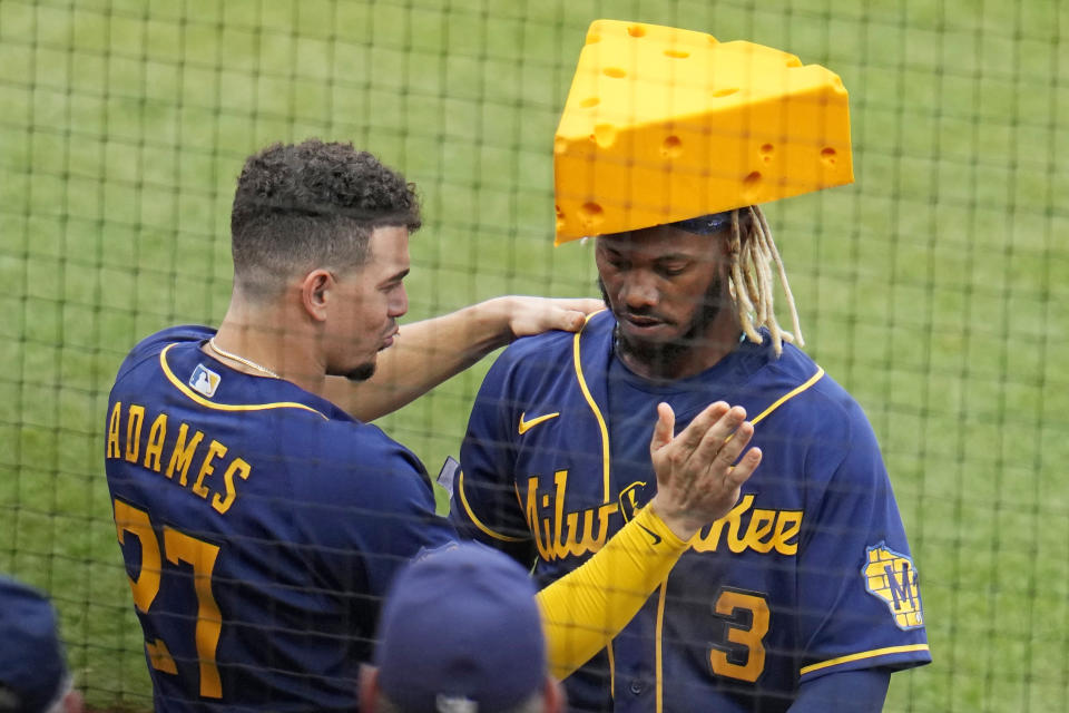 Milwaukee Brewers' Raimel Tapia (3) is greeted at the dugout steps by Willy Adames after Tapia's solo home run off Pittsburgh Pirates relief pitcher Roansy Contreras during the seventh inning of a baseball game in Pittsburgh, Saturday, July 1, 2023. (AP Photo/Gene J. Puskar)
