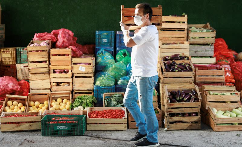 Former Brazil's head soccer coach Dunga helps with food distribution to poor people, amid the coronavirus disease (COVID-19) outbreak, in Porto Alegre