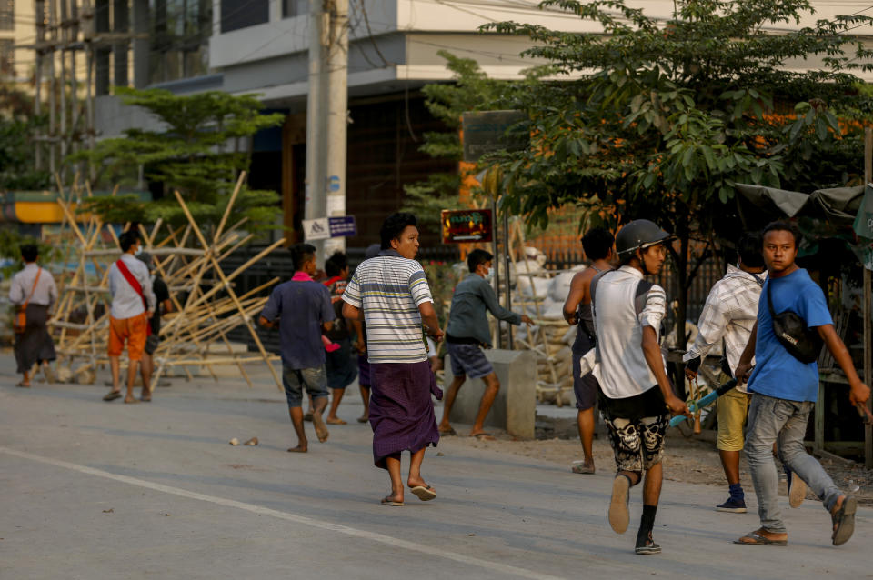 Anti coup protesters run as riot policemen and soldiers crack down on a demonstration and detain protesters in Mandalay, Myanmar, Tuesday, March 23, 2021. Myanmar’s military junta on Tuesday took the offensive to justify last month's coup and subsequent actions against those opposed to it, even as street demonstrations continued against the takeover.(AP Photo)