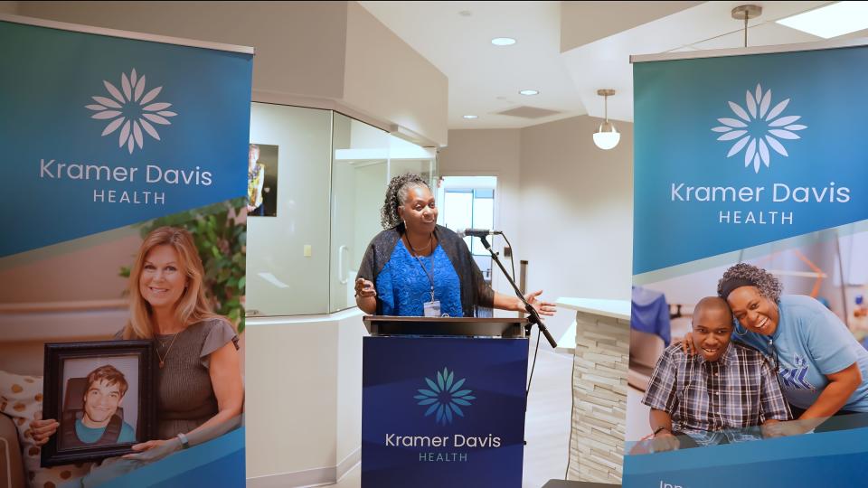 Tina Davis provided opening remarks at October's ribbon-cutting for the new Kramer Davis Health clinic in Nashville. This facility, partially named after her son Terrence Davis, serves individuals with intellectual and developmental disabilities.