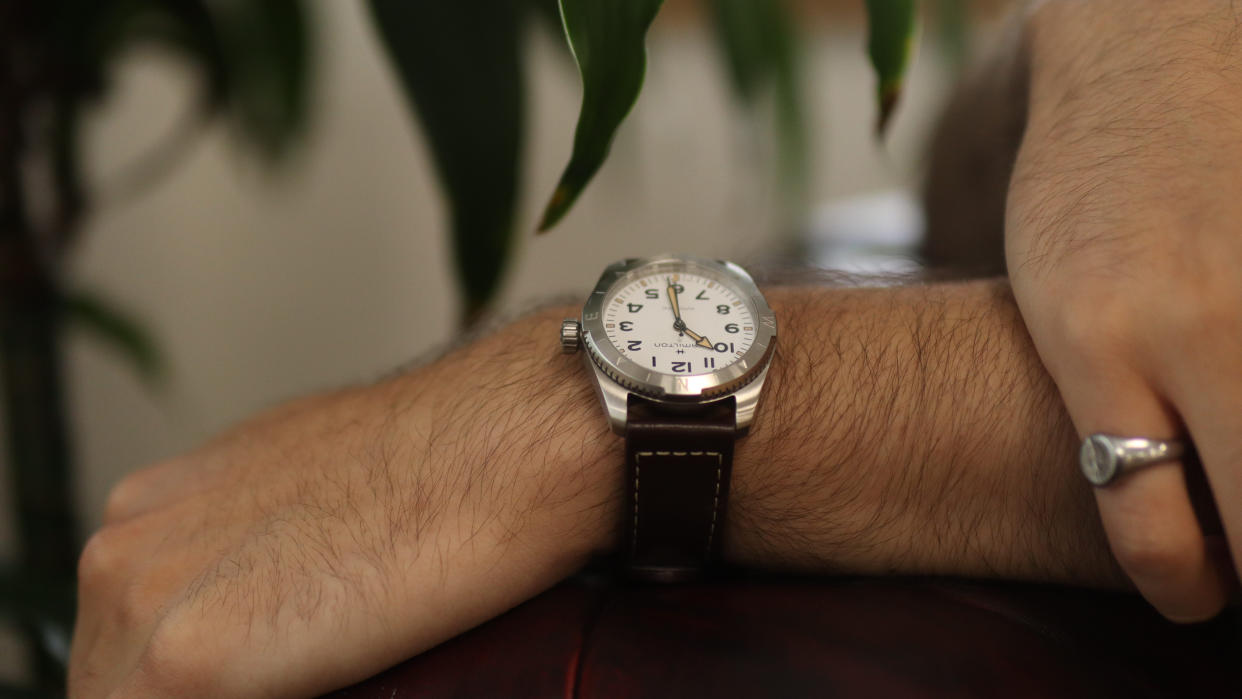  The Hamilton Khaki Field Expedition worn against a green and white background. 