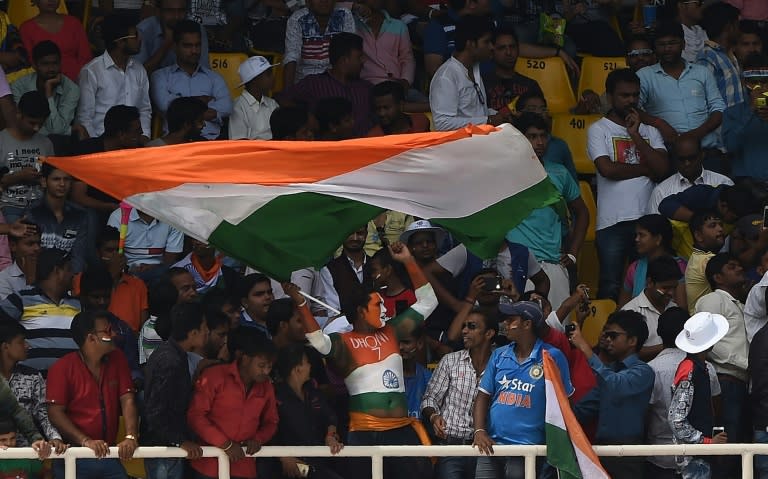 Indian supporters celebrate victory against New Zealand on the fifth day of the first Test in Kanpur on September 26, 2016
