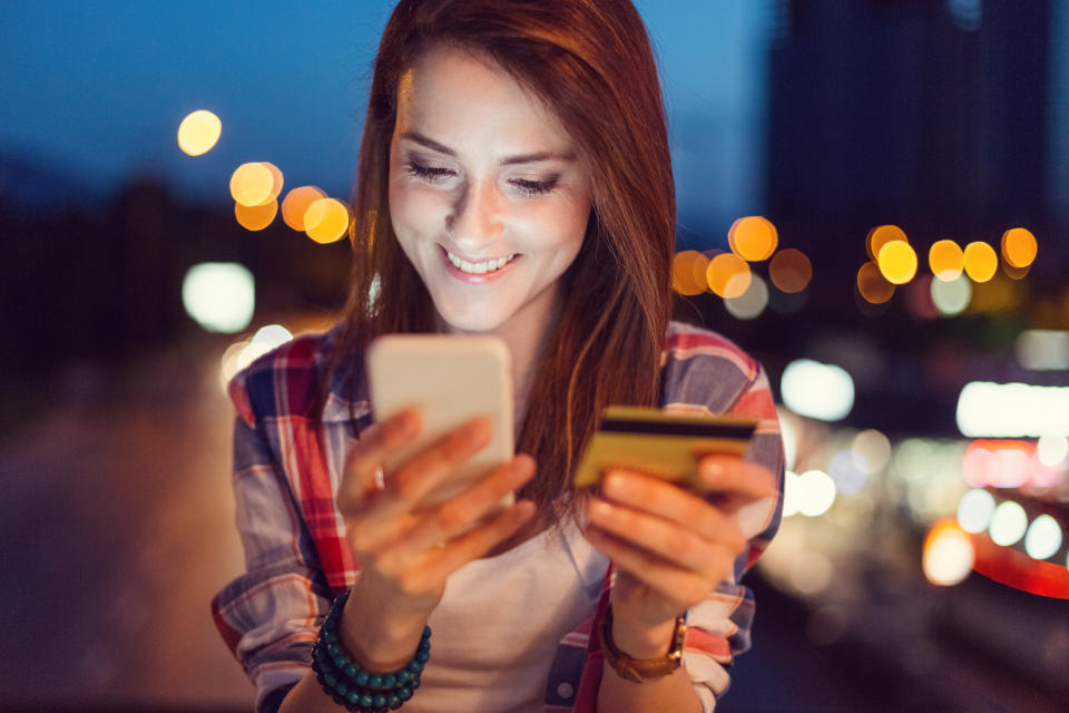 Young women using credit card for online shopping