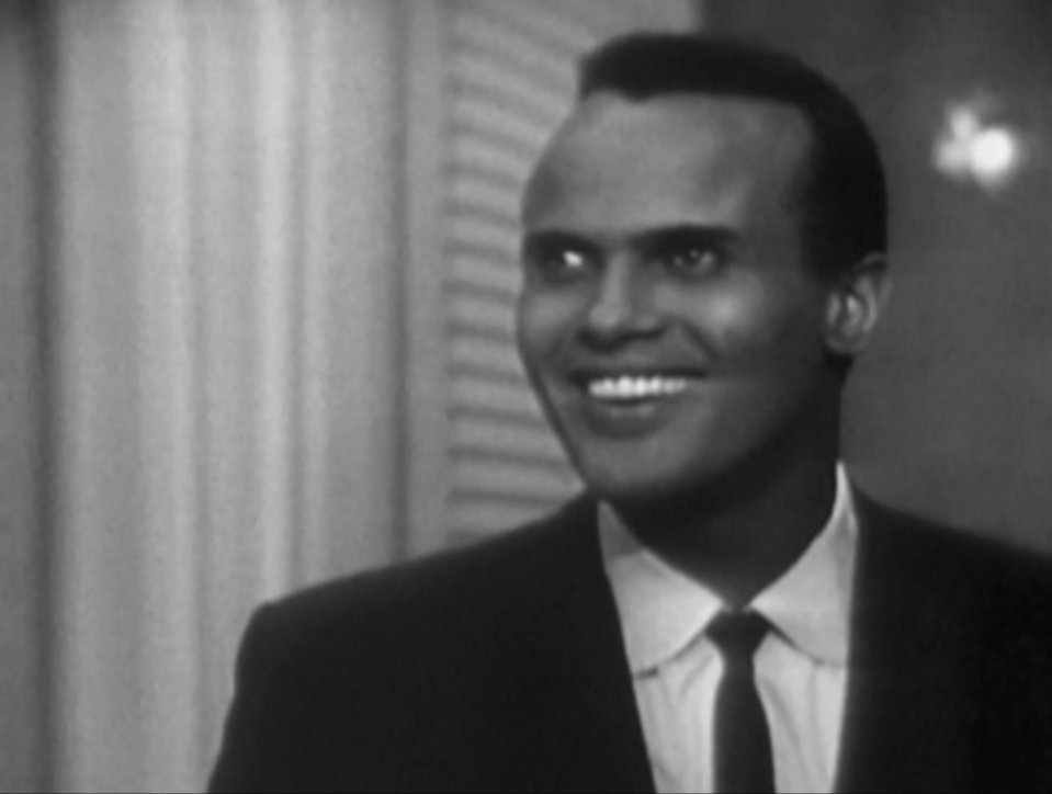 Harry Belafonte smiling in a black-and-white photo