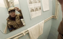 Yuliia Paievska, known as Taira, looks in the mirror and turns off her camera in Mariupol, Ukraine on Feb. 27, 2022. Using a body camera, she recorded her team's frantic efforts to bring people back from the brink of death. (Yuliia Paievska via AP)