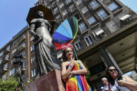 People taking part in a gay pride parade pose before the start of the event in Budapest, Hungary, Saturday, July 24, 2021. Hungary's government led by right-wing Prime Minister Viktor Orban passed a law in June prohibiting the display of content depicting homosexuality or gender reassignment to minors, a move that has ignited intense opposition in Hungary while EU lawmakers have urged the European Commission to take swift action against Hungary unless it changes tack. (AP Photo/Anna Szilagyi)