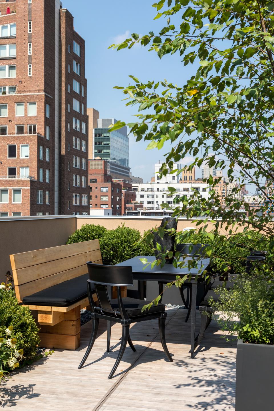 “I’m very afraid of heights, so the outdoor space had to feel safe and secure,” says Dedivanovic. To accomplish this, he and Korban enlisted Brook Landscaping to overhaul the rooftop terrace. The team replaced the wood deck and added black fencing and boxwood hedges for a clean, contemporary look. The table and chair are by RH, and the bench is custom. “Every morning during spring and summer, I spend about an hour up there and watch the sunrise while having coffee and working on emails and social media,” Dedivanovic says. “It's very private and peaceful.”