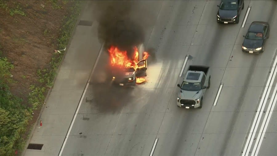 A burning van on the 105 Freeway in the City of Paramount caused delays for commuters early Monday morning. (Sky5)