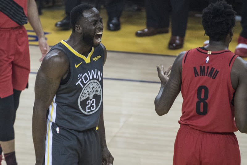 Golden State Warriors forward Draymond Green (L) will miss the next five games because of a suspension. File Photo by Terry Schmitt/UPI