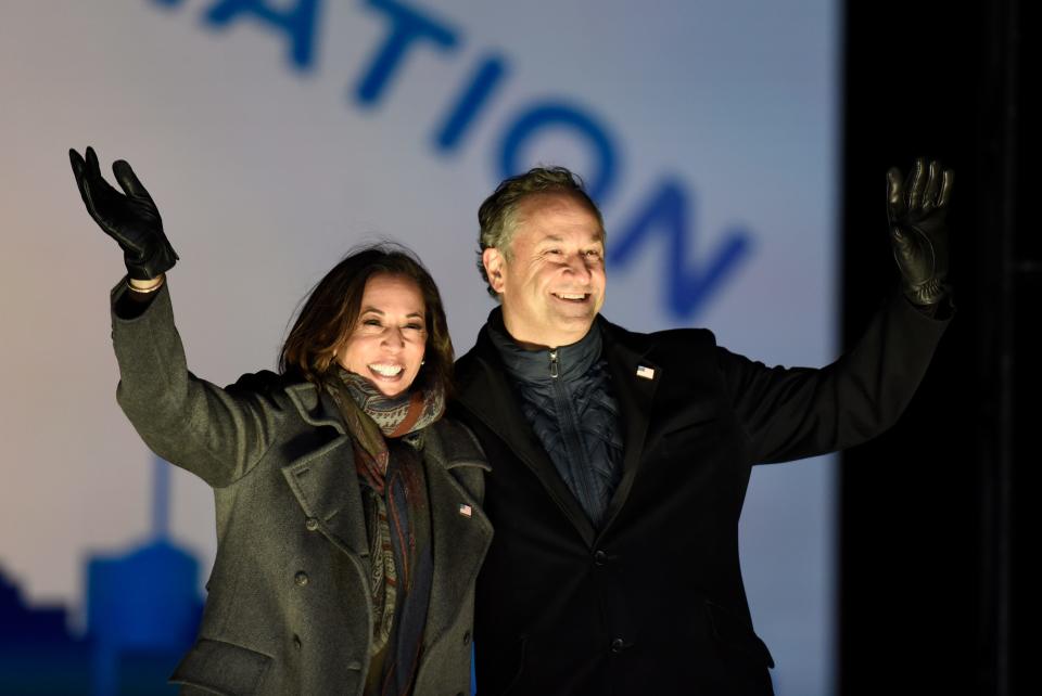 Democratic vice presidential candidate Sen. Kamala Harris, D-Calif., and her husband Doug Emhoff take the stage during a drive-in get out the vote rally, Monday, Nov. 2, 2020, in Philadelphia.