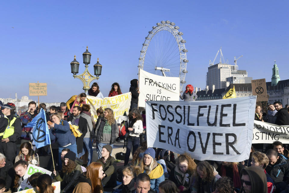 Demonstrators on Westminster Bridge in London, Saturday Nov. 17, 2018, for a protest group called 'Extinction Rebellion' to raise awareness of the dangers posed by climate change. Hundreds of protesters turned out in central London and blocked off the capital’s main bridges to demand the government take climate change seriously. (John Stillwell/PA via AP)