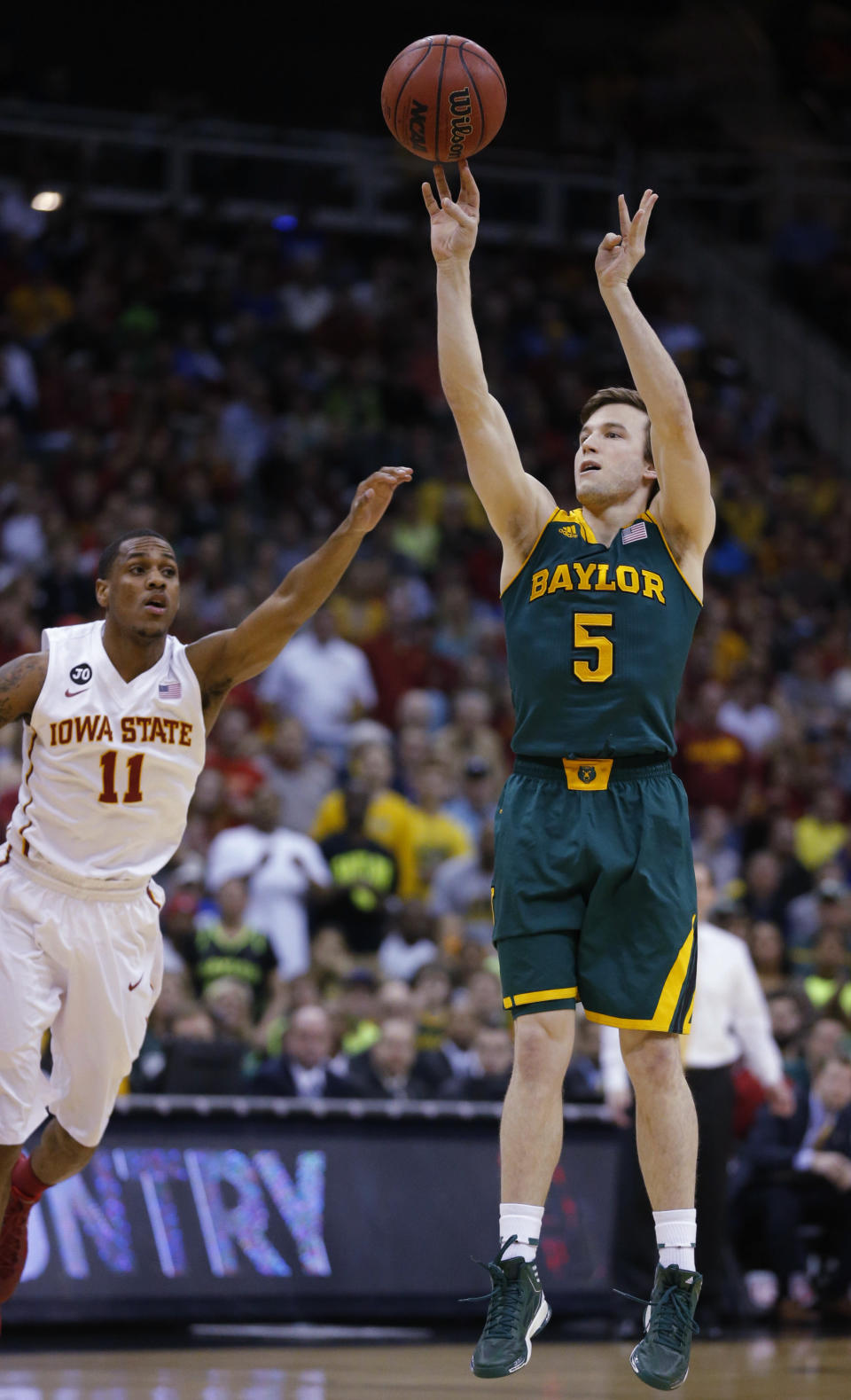 Baylor guard Brady Heslip (5) shoots a 3-point basket as Iowa State guard Monte Morris (11) defends during the first half of an NCAA college basketball game in the final of the Big 12 Conference men's tournament in Kansas City, Mo., Saturday, March 15, 2014. (AP Photo/Orlin Wagner)