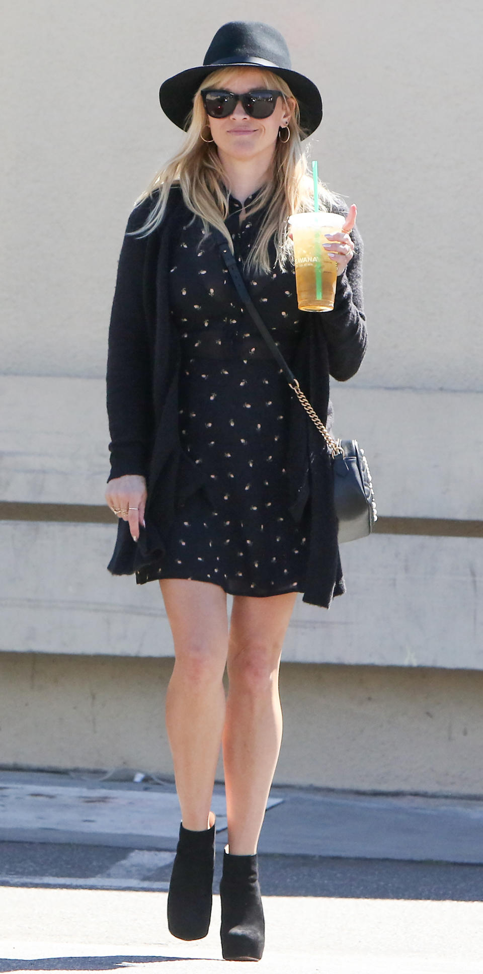 <p>Reese grabbed a Teavana beverage and hit the streets of L.A. in an uncharacteristically dark outfit consisting of a patterned minidress, black fedora, matching cardigan and ankle boots, topped off with a quilted Gucci crossbody bag (shop a similar piece <a rel="nofollow noopener" href="http://click.linksynergy.com/fs-bin/click?id=93xLBvPhAeE&subid=0&offerid=365991.1&type=10&tmpid=2174&RD_PARM1=http%3A%2F%2Fwww.&RD_PARM2=saksfifthavenue.com%2Fmain%2FProductDetail.jsp%3F&RD_PARM3=FOLDER%253C%253Efolder_id%3D2534374306624224%2526PRODUCT%253C%253Eprd_id%3D845524447027524%2526R%3D888108602551%2526P_name%3DGucci%2526N%3D4294912411%2B306624224%2526bmUID%3DlGFyO9m&u1=ISReeseWSSGucciCrossbodIJMarch" target="_blank" data-ylk="slk:here;elm:context_link;itc:0;sec:content-canvas" class="link ">here</a>). </p>