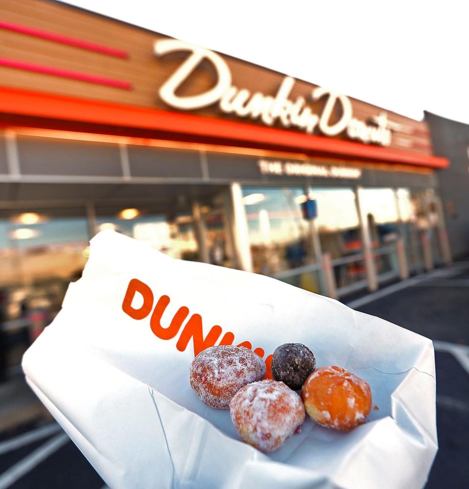 Dunkin' Munchkins, with the original Dunkin' Donuts location in Quincy in the background.