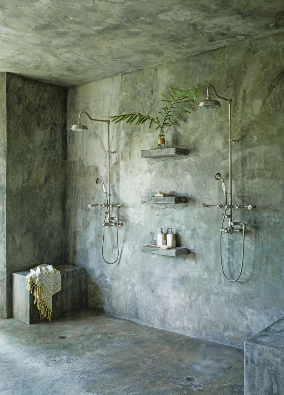 en suite bathroom wanted it to feel calm, quiet, and seamless says liess of the concrete, cave like shower area coated in waterproof stucco hardware existing