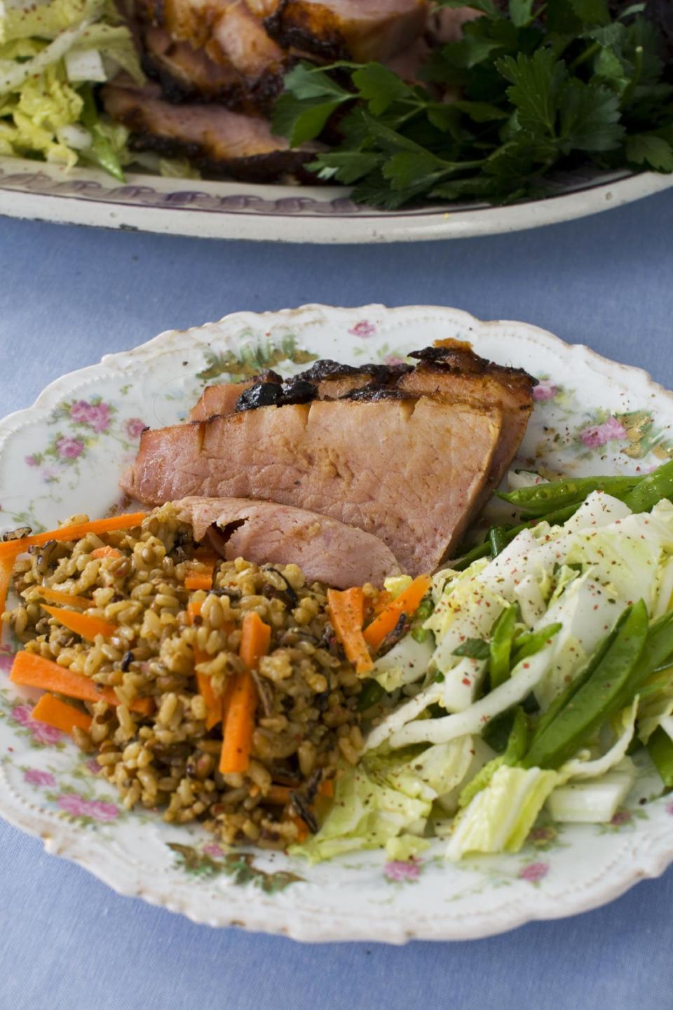 In this image taken on March 11, 2013, hoisin-glazed ham with Napa cabbage-snow pea slaw is shown served on a plate in Concord, N.H. (AP Photo/Matthew Mead)