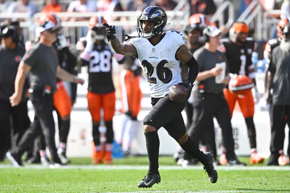 Ravens safety Geno Stone celebrates after intercepting a pass in the first quarter against the Browns.